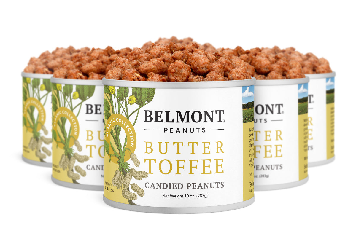 Five cans of Butter Toffee are grouped together, with the front can fully visible and the others partially behind. Each can is filled to the top with peanuts coated in a rich, buttery candy shell.