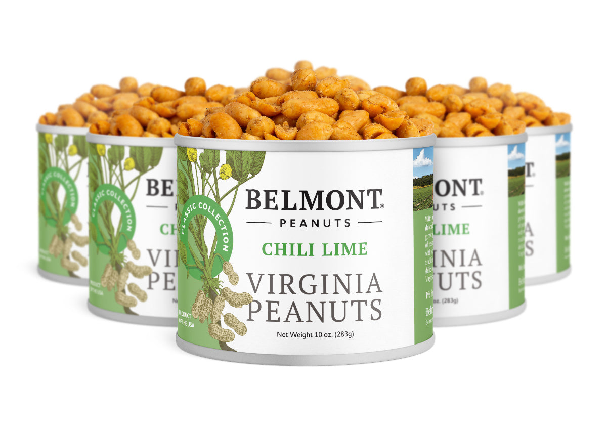 Five cans of Chili Lime are arranged in a staggered formation, each filled with Citrus Chili Pepper peanuts—tasty protein snacks in green and white cans decorated with peanut plant illustrations.