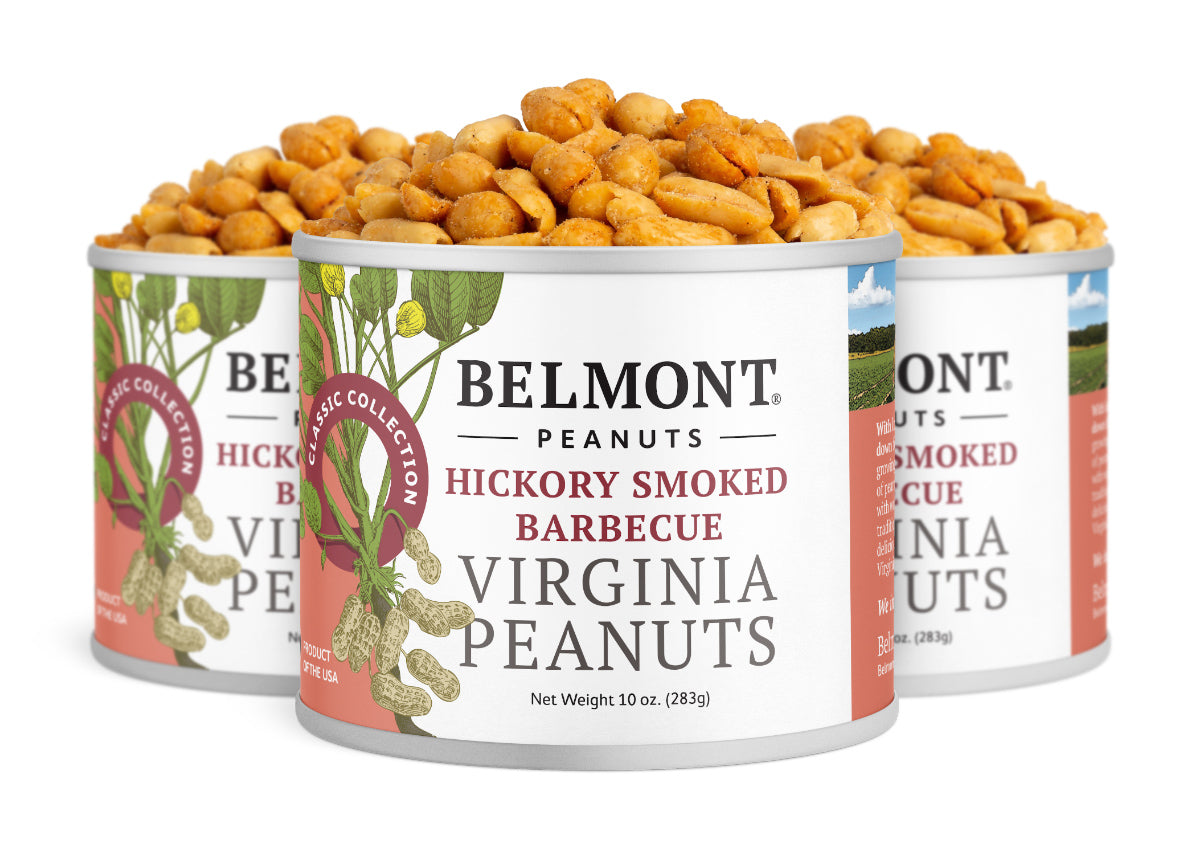 Three cans of Hickory Smoked BBQ Virginia Peanuts offer sweet hickory flavor. The red and white cans display peanut illustrations and open lids, showcasing the tasty, barbecue-seasoned peanuts inside.