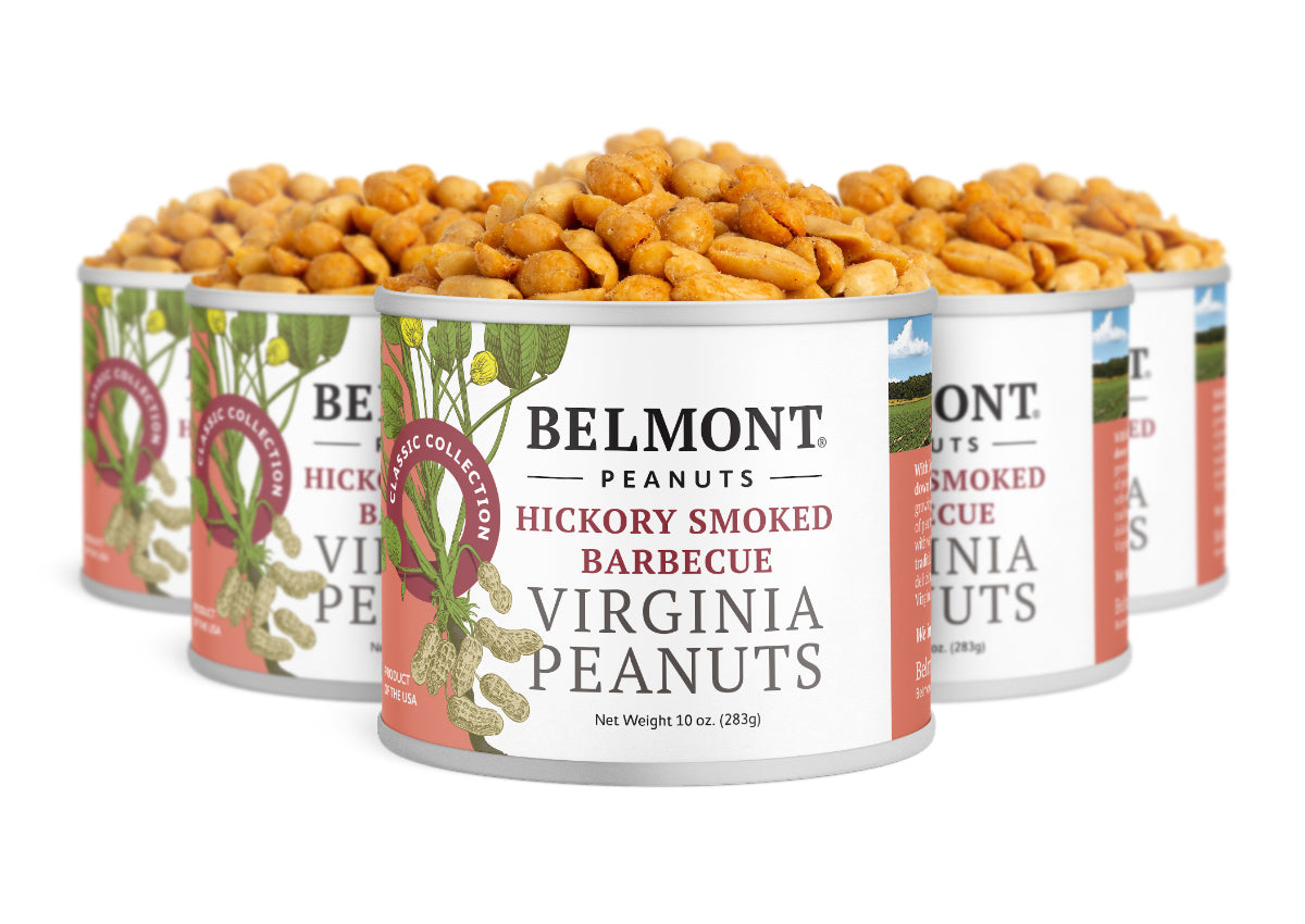 Five cans of Hickory Smoked BBQ peanuts are grouped together, overflowing with savory hickory smoked flavor. The red and white labels make them a tasty choice for fans of sweet, smoky snacks.