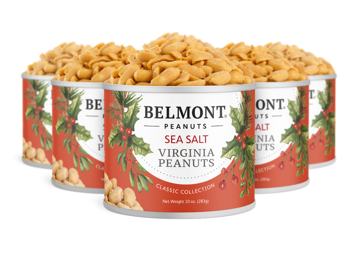 Six cans of Belmont 10 oz. Holiday Sea Salt Peanuts feature festive red and white labels with holiday greenery, highlighting these gourmet peanuts bursting with sea salt flavor.