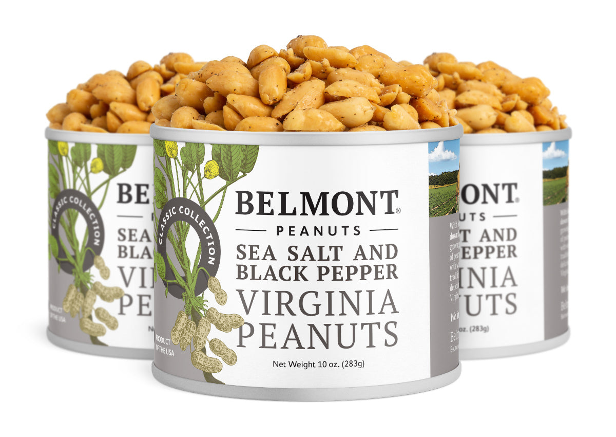 Three cans of Sea Salt & Black Pepper gourmet Virginia peanuts are shown, filled with seasoned peanuts. The packaging features peanut illustrations and green accents.