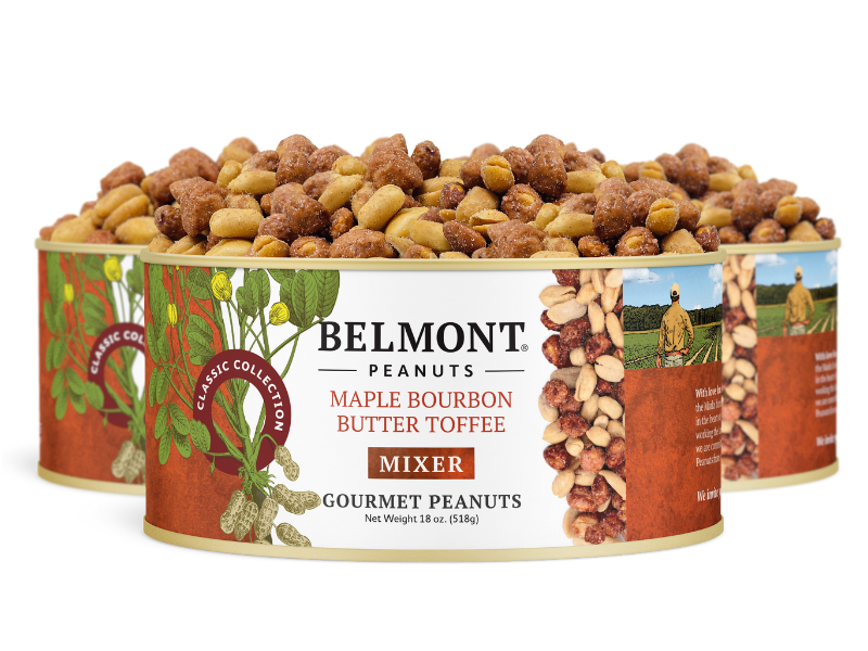Three tins of Maple Bourbon Butter Toffee Mixer labeled “Gourmet Peanuts” are displayed, showcasing butter toffee peanuts with maple bourbon spice. The packaging features images of peanuts, greenery, and a person in a field.