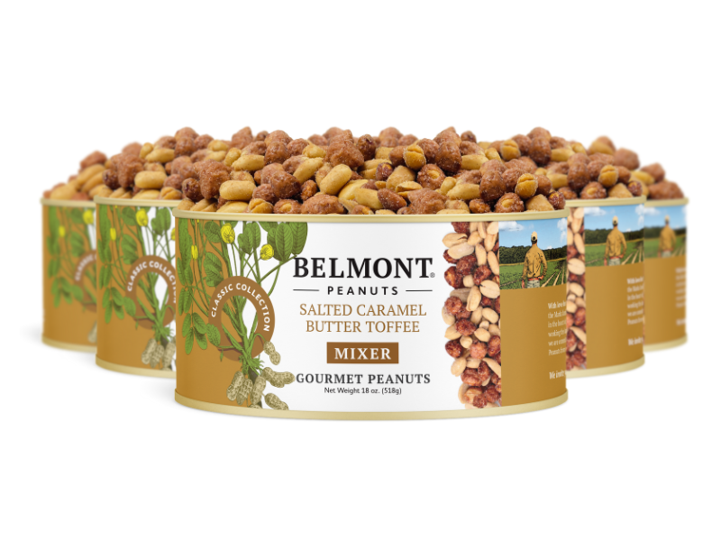 Four cans of Salted Caramel Butter Toffee Mixer are arranged in a staggered row, open to reveal the coated peanuts inside. The label displays images of peanuts and green leaves.