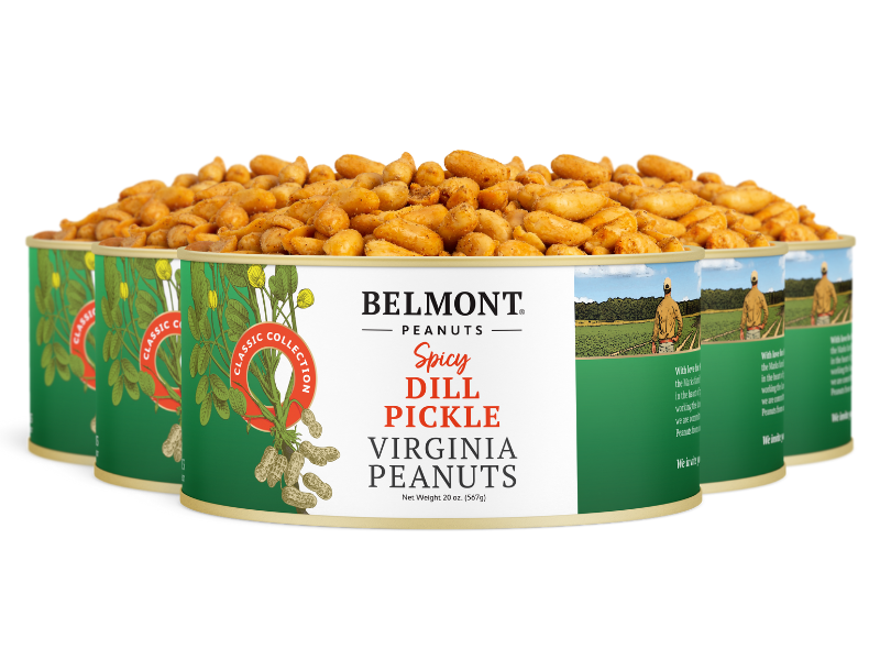 Four tins of Spicy Dill Pickle Virginia peanuts, with one open and overflowing with this bold, spicy snack. The green and white label shows peanuts and a field.