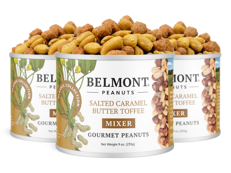 Three cans of Salted Caramel Butter Toffee Mixer are shown, each filled with coated peanuts. The cans are labeled “Mixer” and display nut and peanut illustrations on the sides.