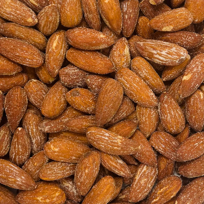 A close-up of Almonds reveals their brown, textured surfaces and visible salt crystals—making these Almonds the perfect snack for any craving.