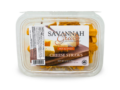 A clear plastic container of Hot & Spicy Cheese Straws, 6 oz, with a label showing cheese blocks and the product name on a wooden board—ideal for fans of spicy snacks and savory treats.