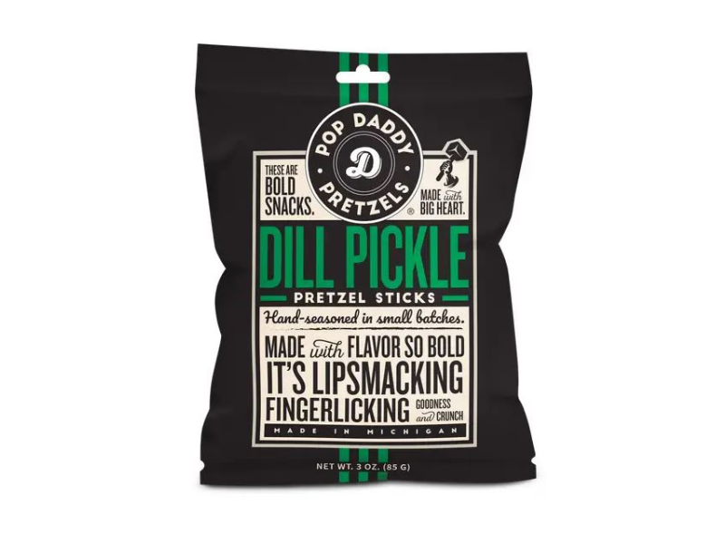 A black bag of Dill Pickle Pretzel Sticks features bold white and green text highlighting these hand-seasoned, zesty dill snacks as lip-smacking, finger-licking, and made in Michigan. Net weight: 3 oz.