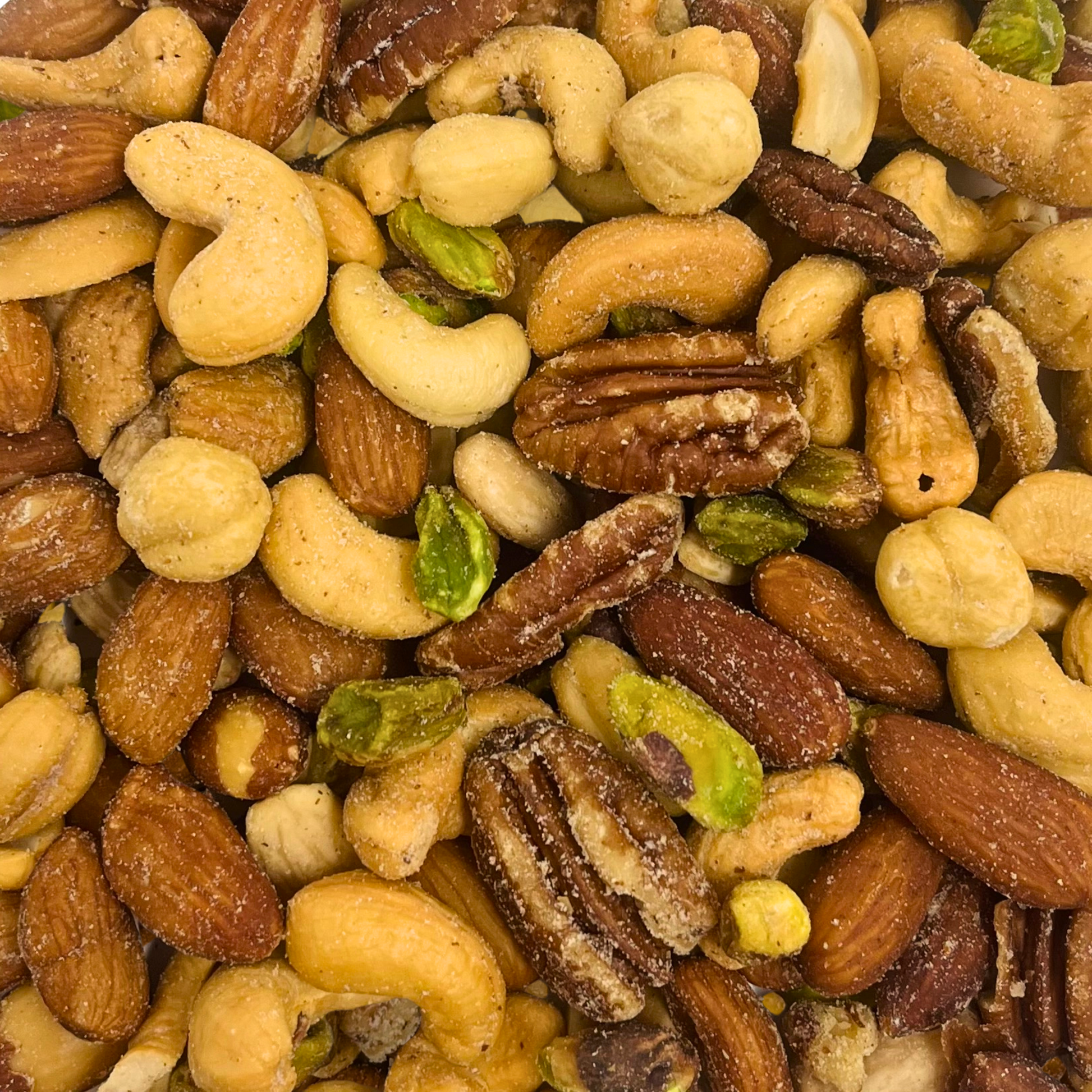 A close-up of Mixed Nuts—a gourmet assortment of almonds, cashews, pecans, pistachios, and hazelnuts, lightly salted and roasted to perfection—fills the frame for an irresistible snack.