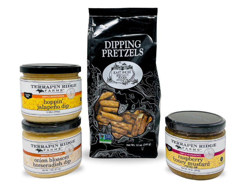 Three Terrapin Ridge Farms dip jars (hoppin’ jalapeño, onion blossom horseradish, raspberry honey mustard) are arranged with a bag of Dipping Pretzels, perfect for snack customization, all displayed on a white background.
