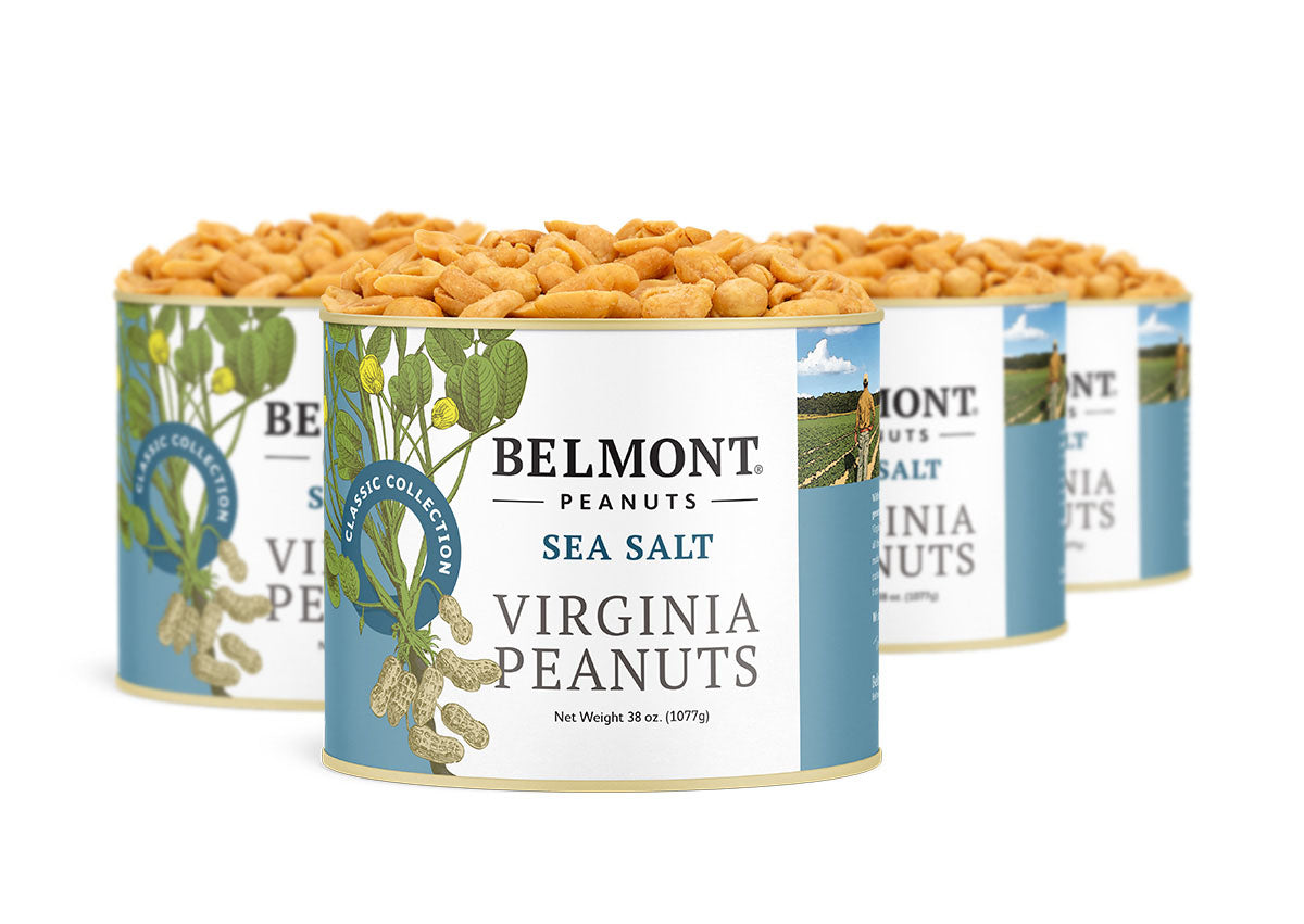 Four cans of Sea Salt Virginia Peanuts are displayed together, featuring gourmet peanuts in blue and white packaging with peanut plant graphics and highlighted text.