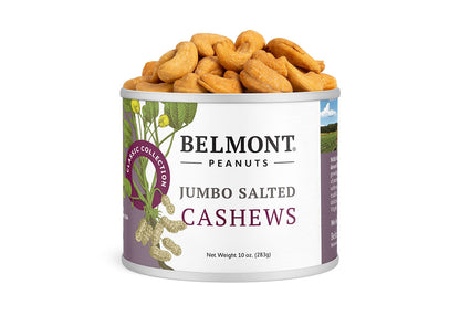 A 10 oz can of Jumbo Salted Cashews with golden roasted cashews spilling out of the open top—a delicious, healthy snack for any occasion. The white label features purple accents and a peanut plant illustration.