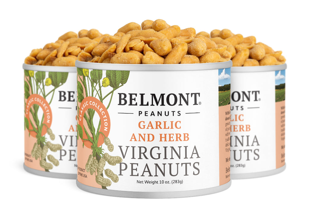 Three open cans of Garlic & Herb gourmet Virginia peanuts, filled to the top and seasoned. The label shows peanuts and green leaves, highlighting them as a tasty protein snack.