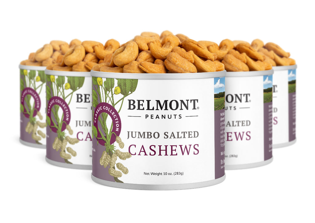Five cans of Jumbo Salted Cashews are displayed together, each can packed with golden roasted cashews. The labels show images of cashew nuts alongside green leaves, emphasizing this healthy snack choice.