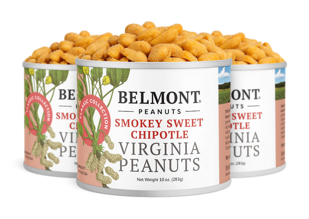Three cans of Smokey Sweet Chipotle peanuts are arranged in a row, each filled with coated, protein-packed snacks and featuring vibrant labels with lively peanut illustrations.
