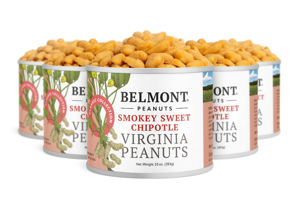 Five cans of Smokey Sweet Chipotle Virginia Peanuts are grouped together, each with a white label displaying peanuts and red text that highlights their protein-packed content and bold, smoky-sweet chipotle flavor.
