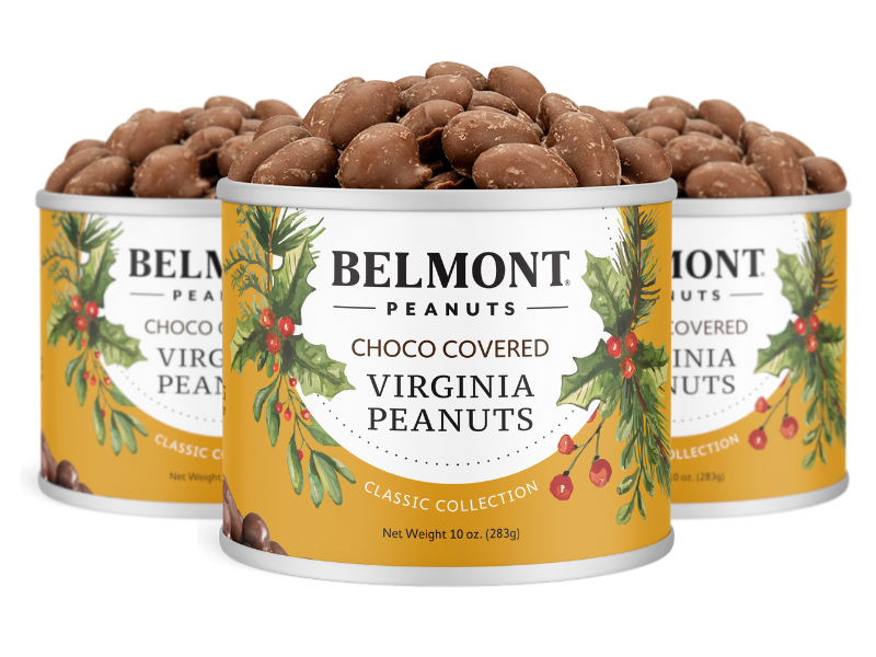 Three cans of Holiday Chocolate Covered Peanuts make a perfect holiday gift, each with festive yellow labels featuring greenery and red berries and filled to the top with gourmet chocolate-covered peanuts.