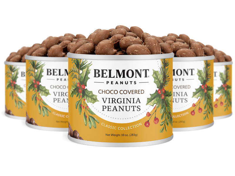 Five tins of Holiday Chocolate Covered Peanuts are grouped together, each decorated with festive greenery and red berries. Open tins reveal gourmet peanuts, making them a perfect gift for the holidays.