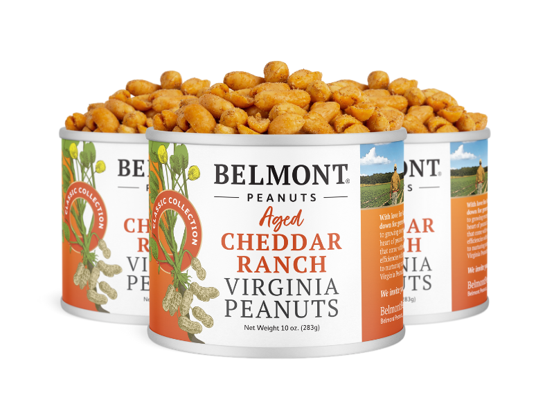 Three tins of Aged Cheddar Ranch peanuts sit side by side, their labels featuring peanuts, greenery, and the bold product name. Each open tin reveals the savory snack inside.