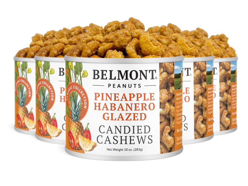 Five cans of Pineapple Habanero Glazed Candied Cashews are stacked, with colorful labels showing pineapple, habanero peppers, and candied cashews—making them the perfect spicy snack for any occasion.