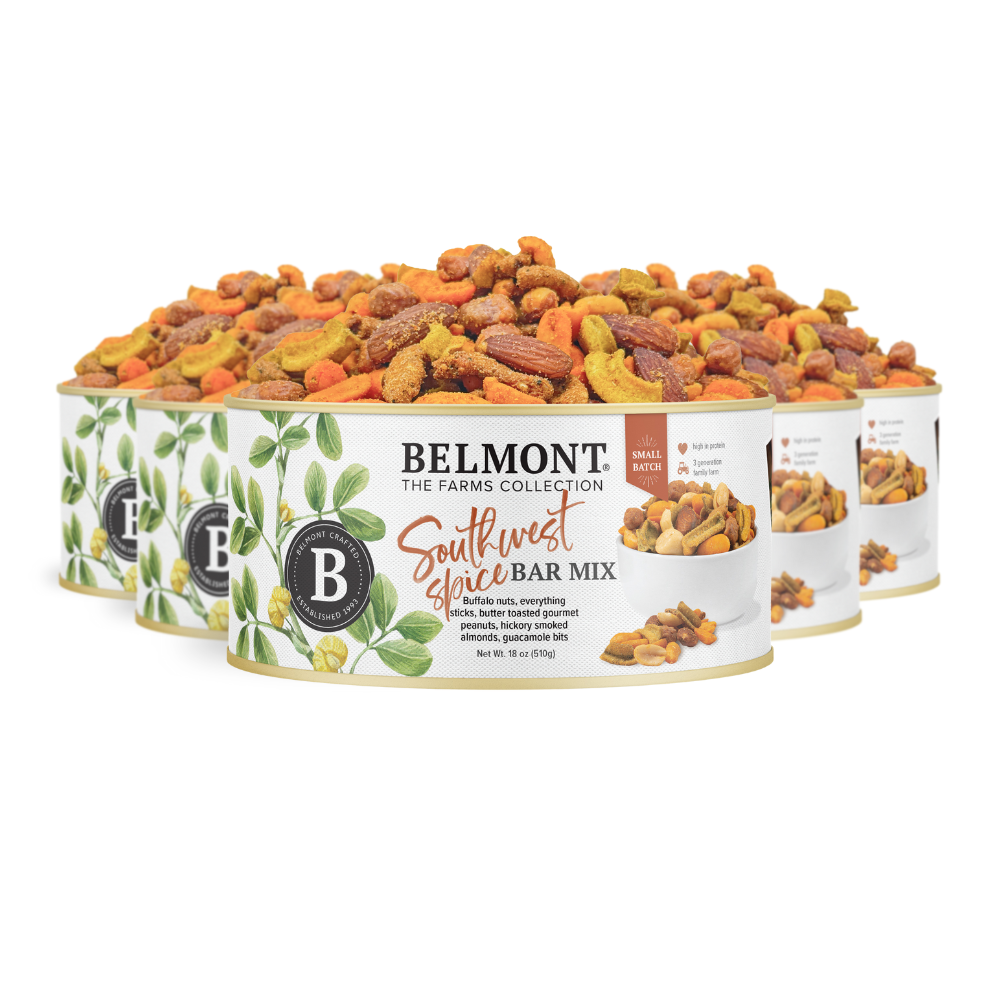 Four cans of Southwest Spice Bar Mix, each with an illustrated leafy label, feature a vibrant blend of seasoned snack nuts, including Gourmet Peanuts and Hickory Smoked Almonds.