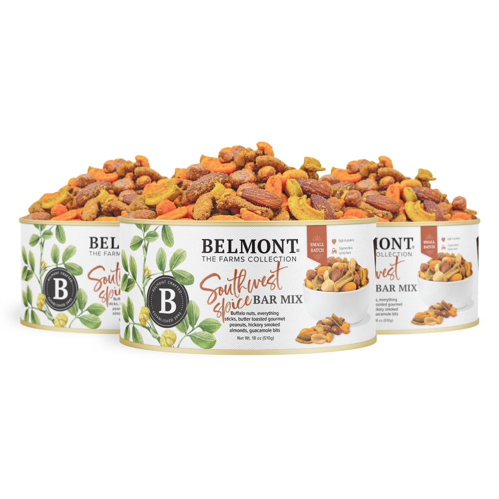 Three cans of Southwest Spice Bar Mix are arranged in a row, featuring leafy designs and images that showcase a vibrant mix of Gourmet Peanuts, assorted nuts, and crunchy pieces.