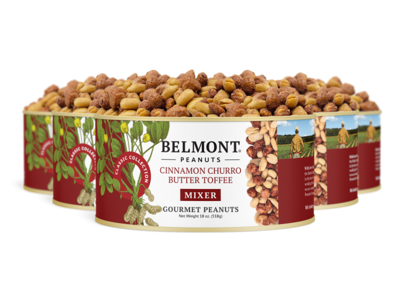 Four cans of Cinnamon Churro Butter Toffee Mixer, featuring butter toffee peanuts coated in sweet cinnamon. The red and cream labels with green leaf accents highlight this gourmet candied peanut mix.