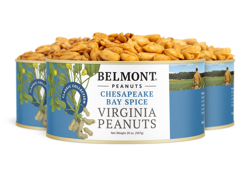 Three tins of Chesapeake Bay Spice seasoned peanuts are shown, each with a blue label featuring peanuts and a person in a field. The cans are arranged with one tin in the front for clear visibility.
