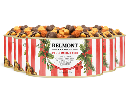 Three tins of Belmont 20 oz. 6-Pack Holiday Peppermint Mix are stacked, showing red and white stripes, festive greenery, and a label highlighting butter toffee, chocolate-covered, and sea salt peanuts inside.