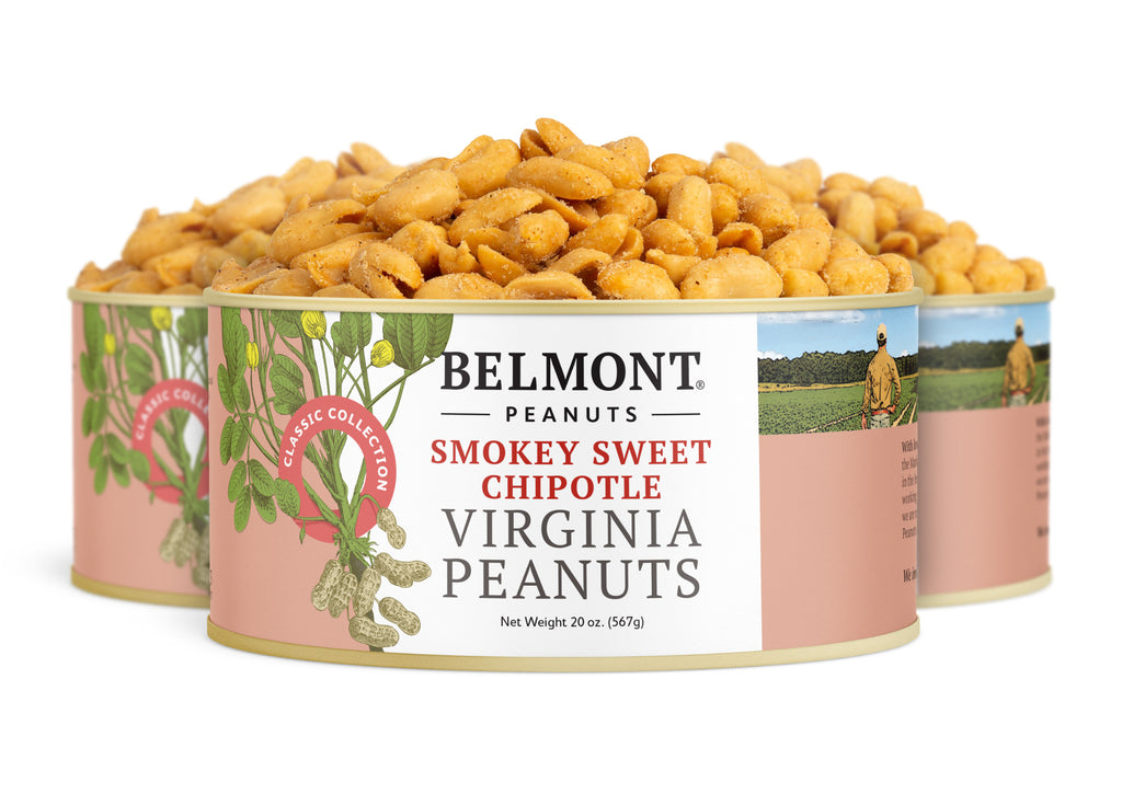 Three cans of Smokey Sweet Chipotle peanuts are stacked, showing the front label with peanut illustrations, the product name, and a background image of a farmer—delicious, protein-packed snacks.
