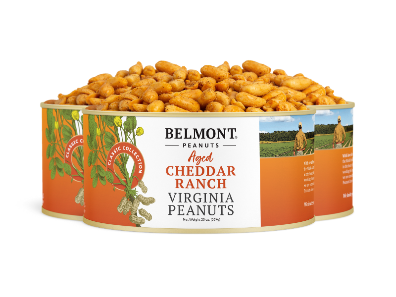 Three cans of Aged Cheddar Ranch Virginia peanuts sit together, their orange and white labels showing a farmer and peanuts. The open cans display seasoned, flavorful Virginia peanuts for a savory snack.