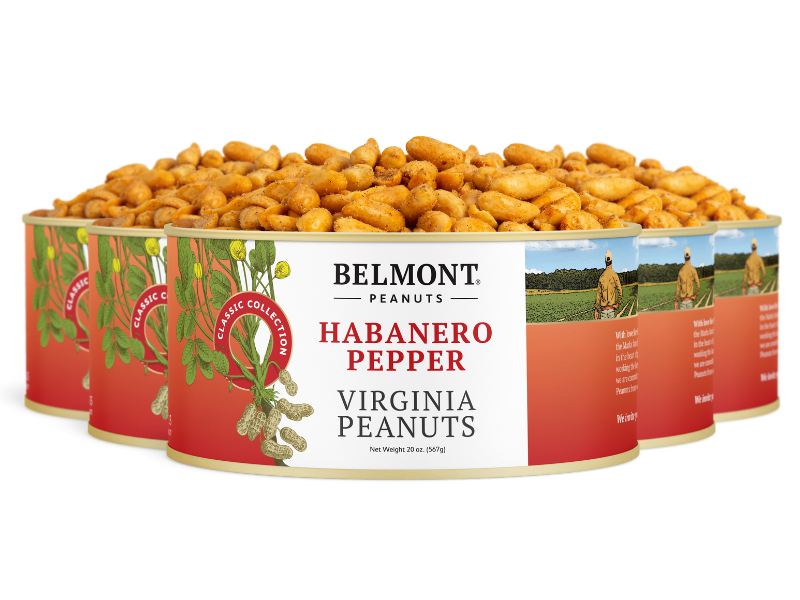 Four cans of Habanero Pepper peanuts are lined up, with the front can open and full of spicy peanuts. The label features red accents and peanut plant images, highlighting this bold and flavorful snack.