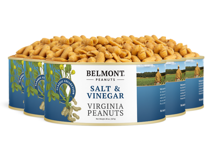 Four cans of Belmont Salt & Vinegar Virginia peanuts, with blue and white labels showing peanuts and a farm scene, are arranged with roasted peanuts spilling out.