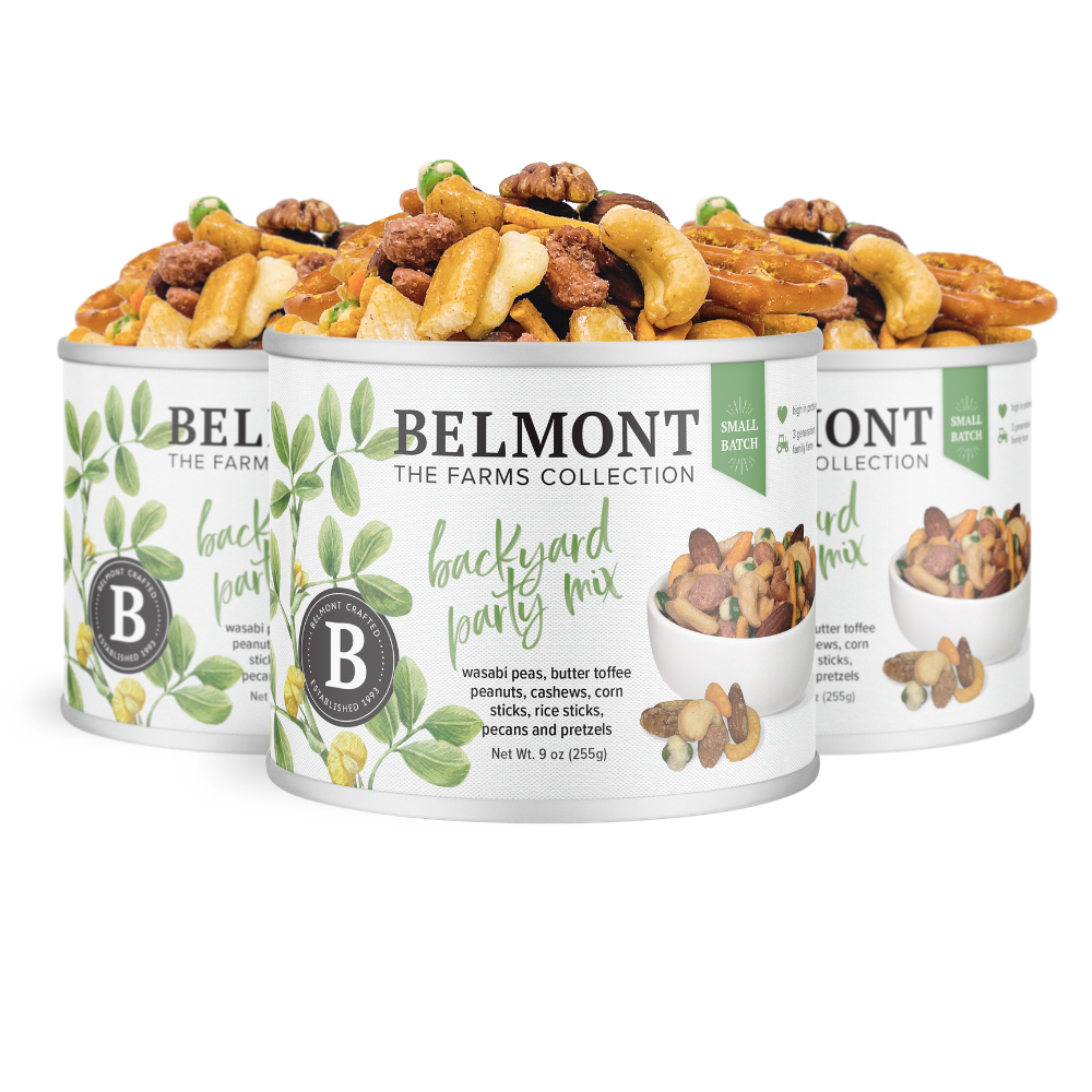 Three cans of Backyard Party Mix, a Belmont Farms Collection snack with butter toffee peanuts, wasabi peas, nuts, pretzels, and more. The cans feature white labels with green leaves, product images, and snacks overflowing from the tops.