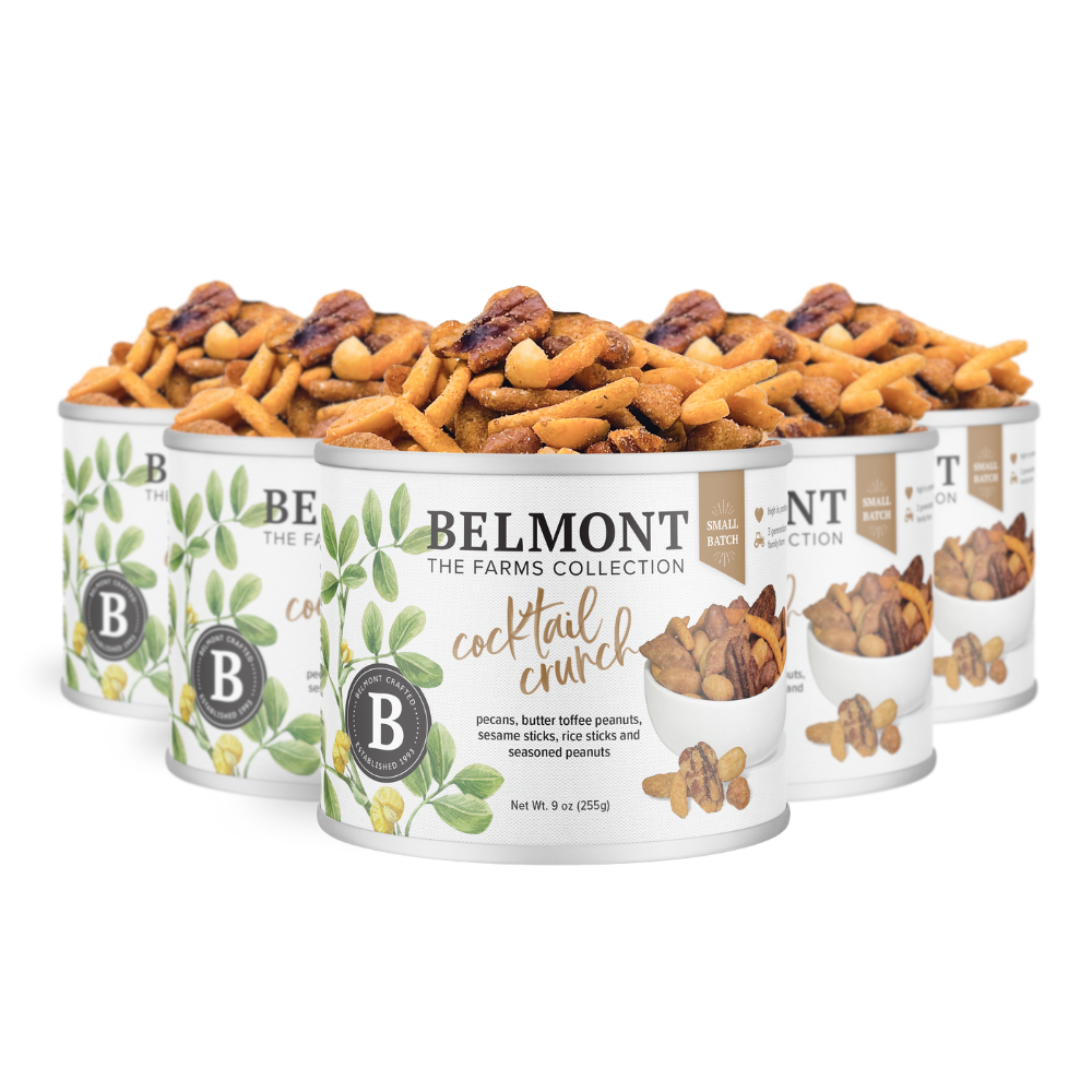 Five cans of Cocktail Crunch Mix are displayed, featuring a leafy design and filled with a tasty blend of pretzels, pecans, Butter Toffee Candied Peanuts, and other crunchy snacks.