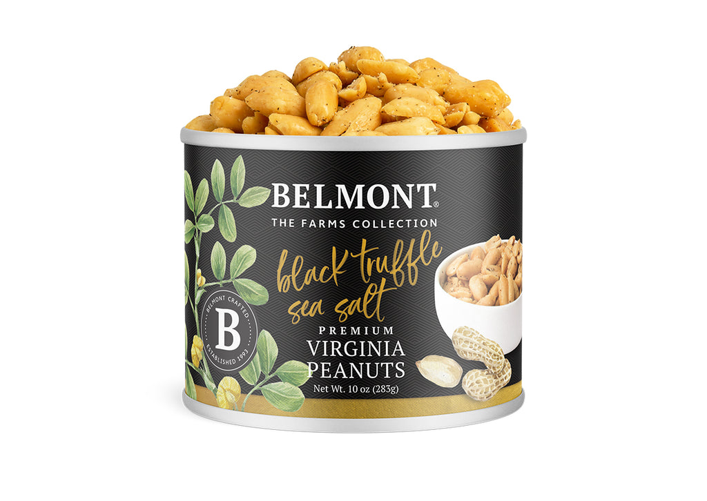 A can of Black Truffle Sea Salt peanuts with peanuts spilling out the top. The label displays green leaves, black truffle accents, images of peanuts, and a small bowl of shelled peanuts against a white background.
